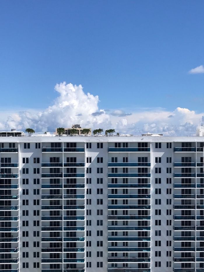 Contemporary skyscraper in Miami Beach under a clear blue sky, showcasing urban architecture.